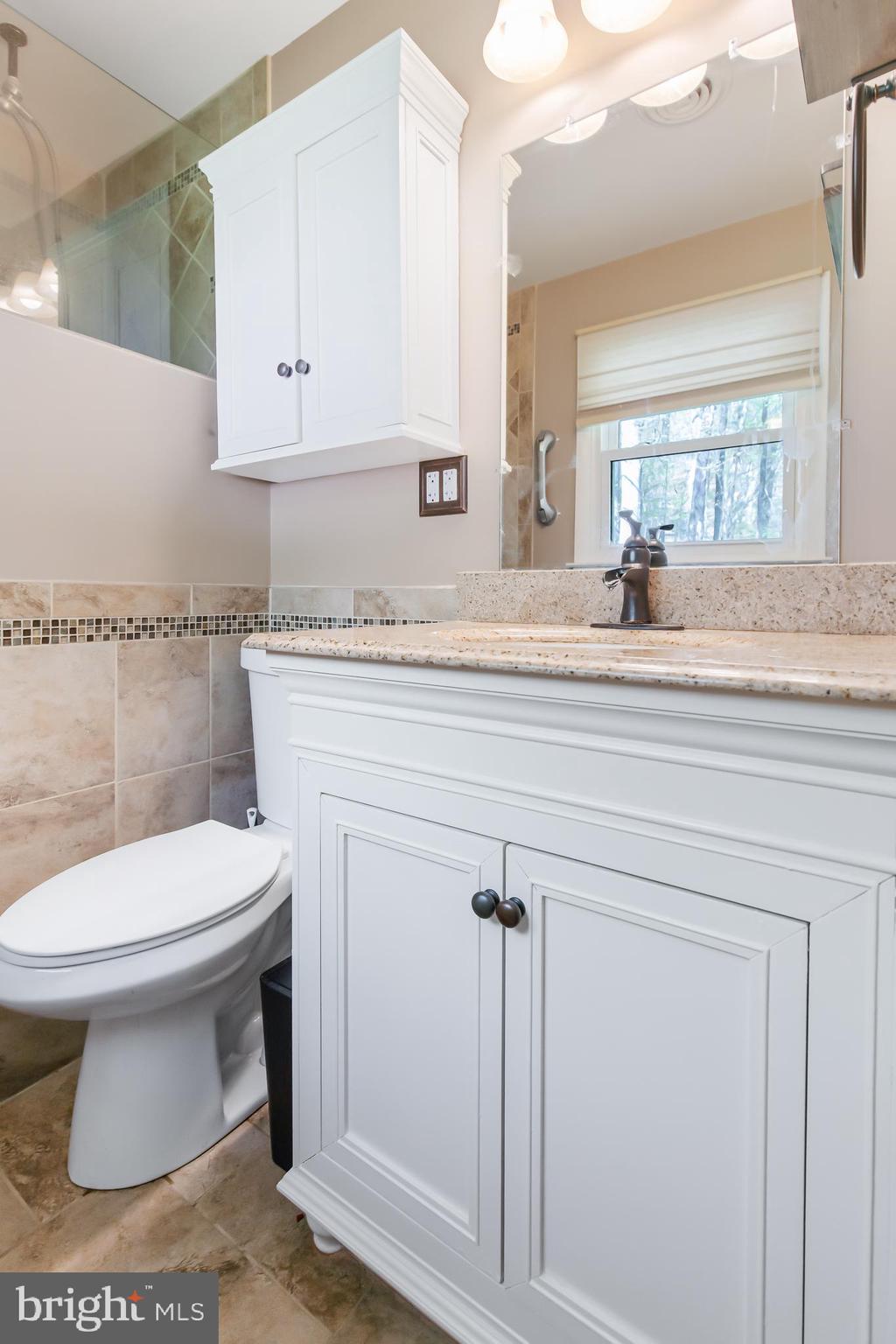 1749 Ramich Road Temple, PA 19560 - Photo 27 of 48 a bathroom with a toilet a sink and mirror