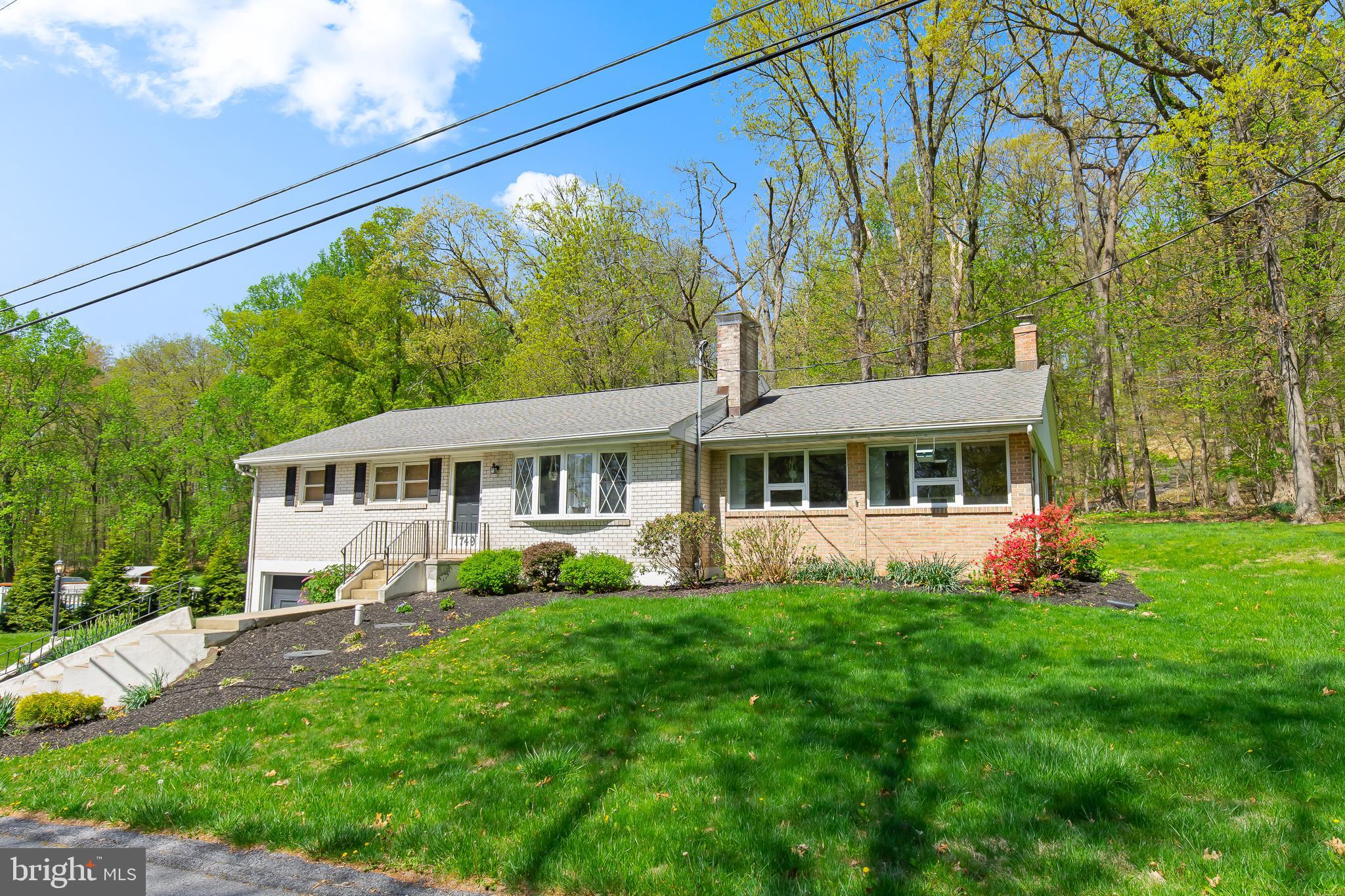 1749 Ramich Road Temple, PA 19560 - Photo 3 of 48 a front view of a house with a garden and trees