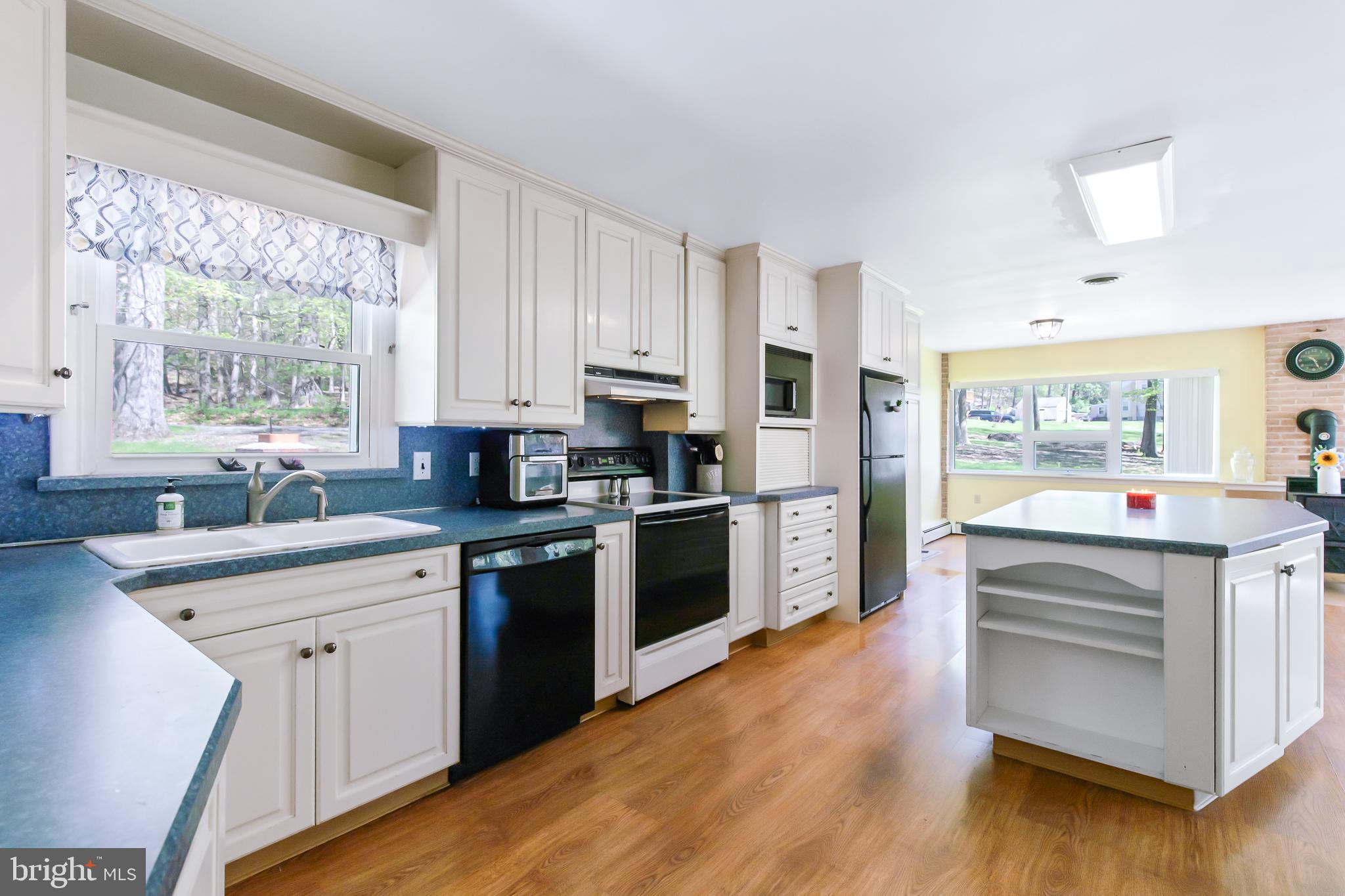 1749 Ramich Road Temple, PA 19560 - Photo 7 of 48 a kitchen with stainless steel appliances granite countertop a stove and cabinets
