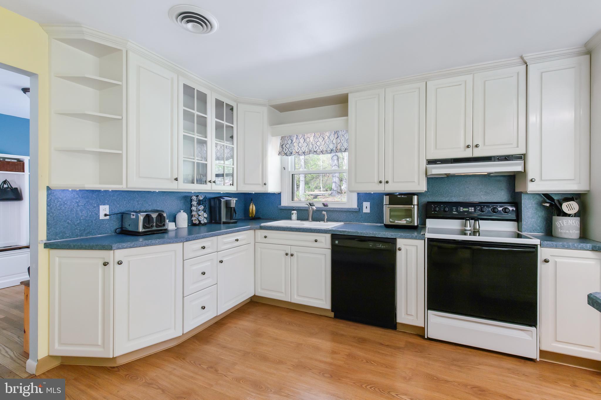 1749 Ramich Road Temple, PA 19560 - Photo 8 of 48 a kitchen with granite countertop white cabinets and white appliances
