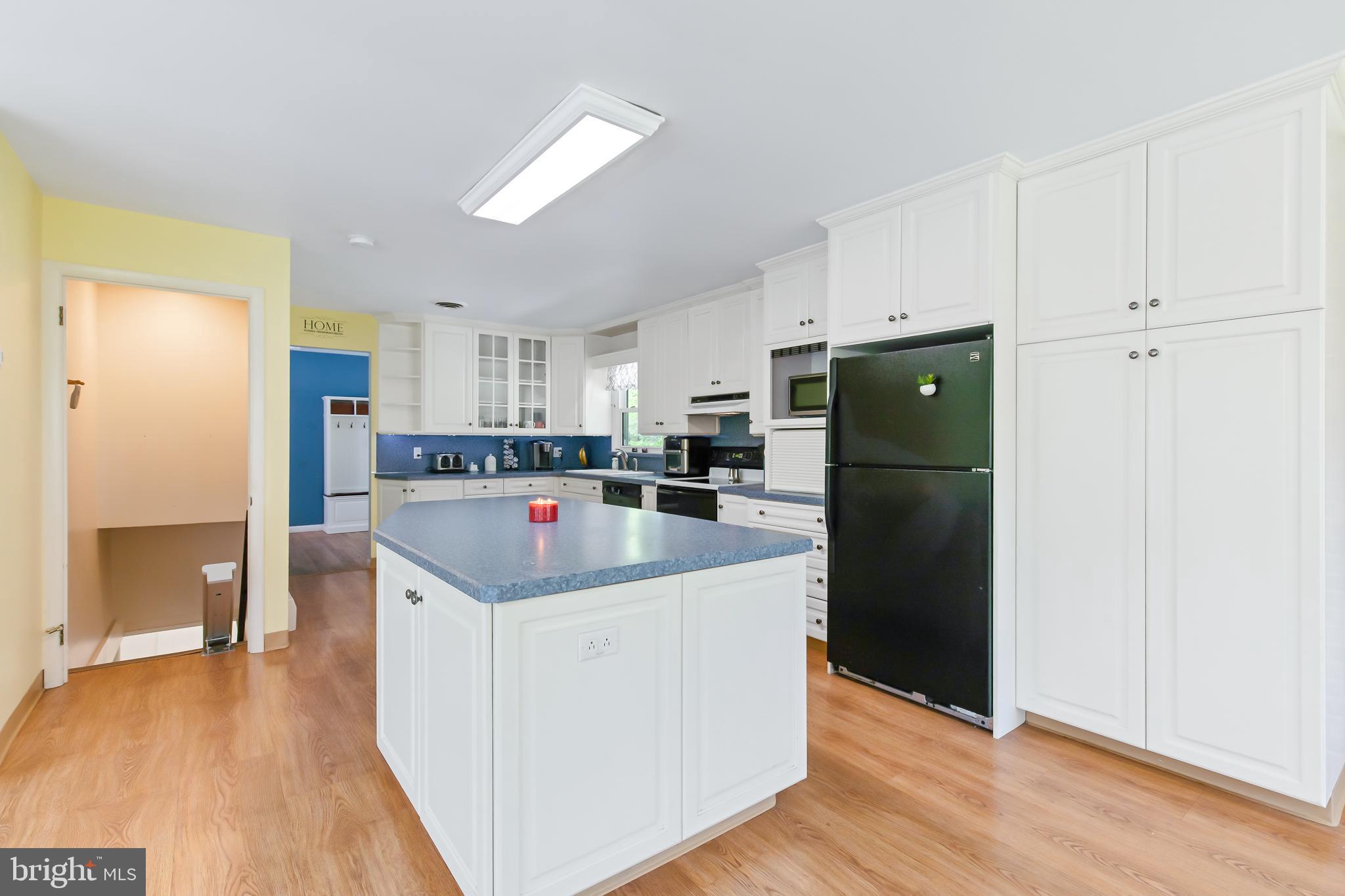 1749 Ramich Road Temple, PA 19560 - Photo 9 of 48 a kitchen with stainless steel appliances kitchen island granite countertop a refrigerator and a cabinets