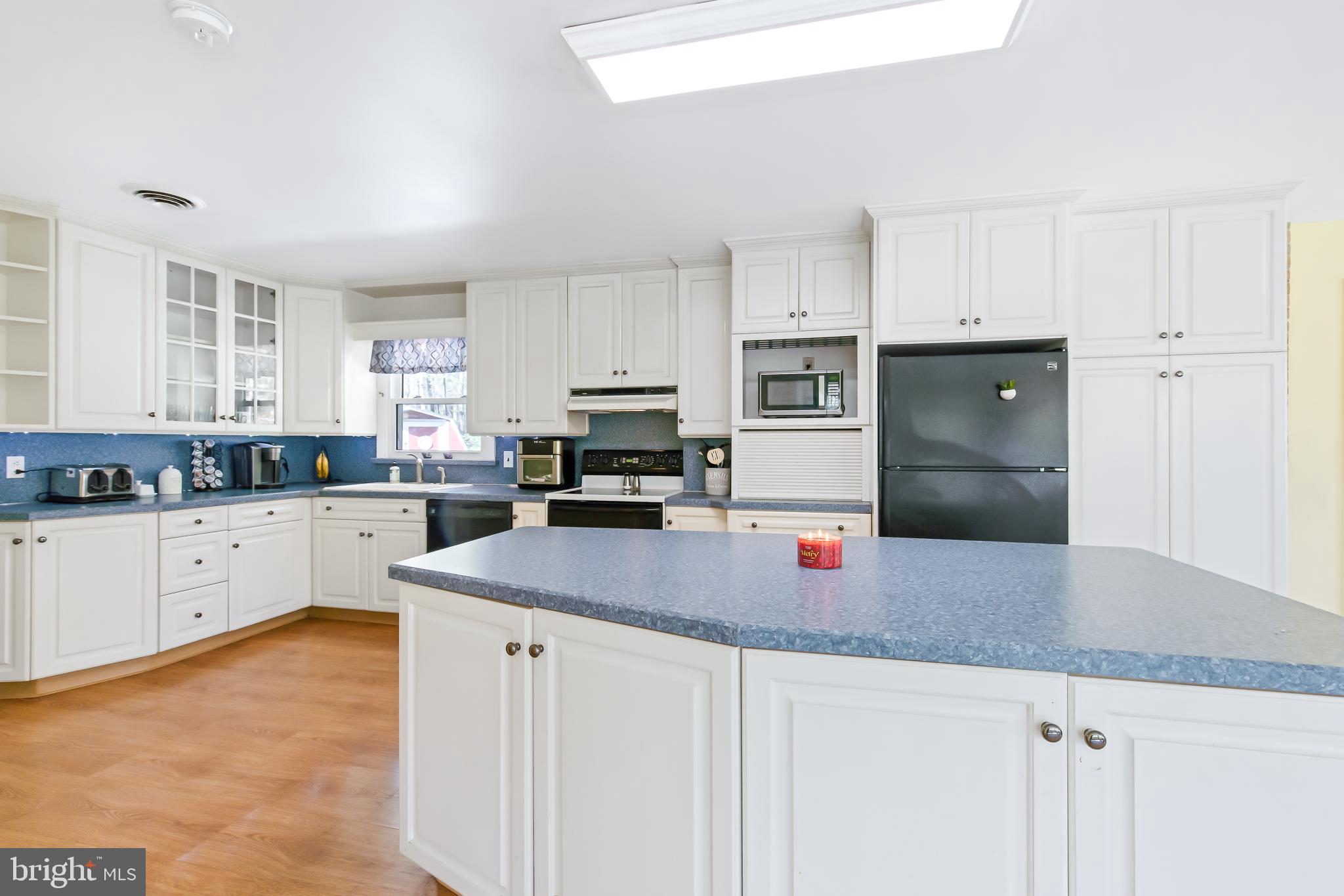 1749 Ramich Road Temple, PA 19560 - Photo 10 of 48 a kitchen with stainless steel appliances granite countertop a sink a refrigerator and white cabinets
