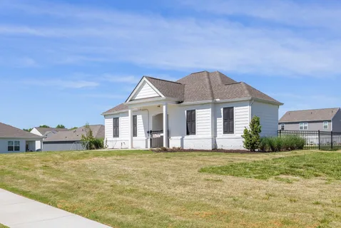 a front view of a house with a yard