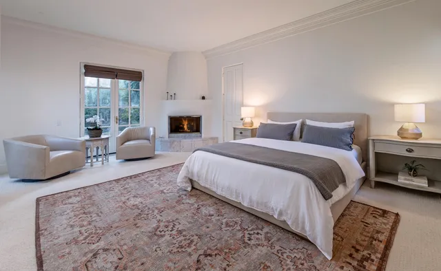 a spacious bedroom with a bed a couch and a window