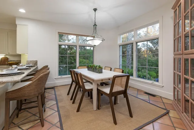 a view of a dining room with furniture window and outside view