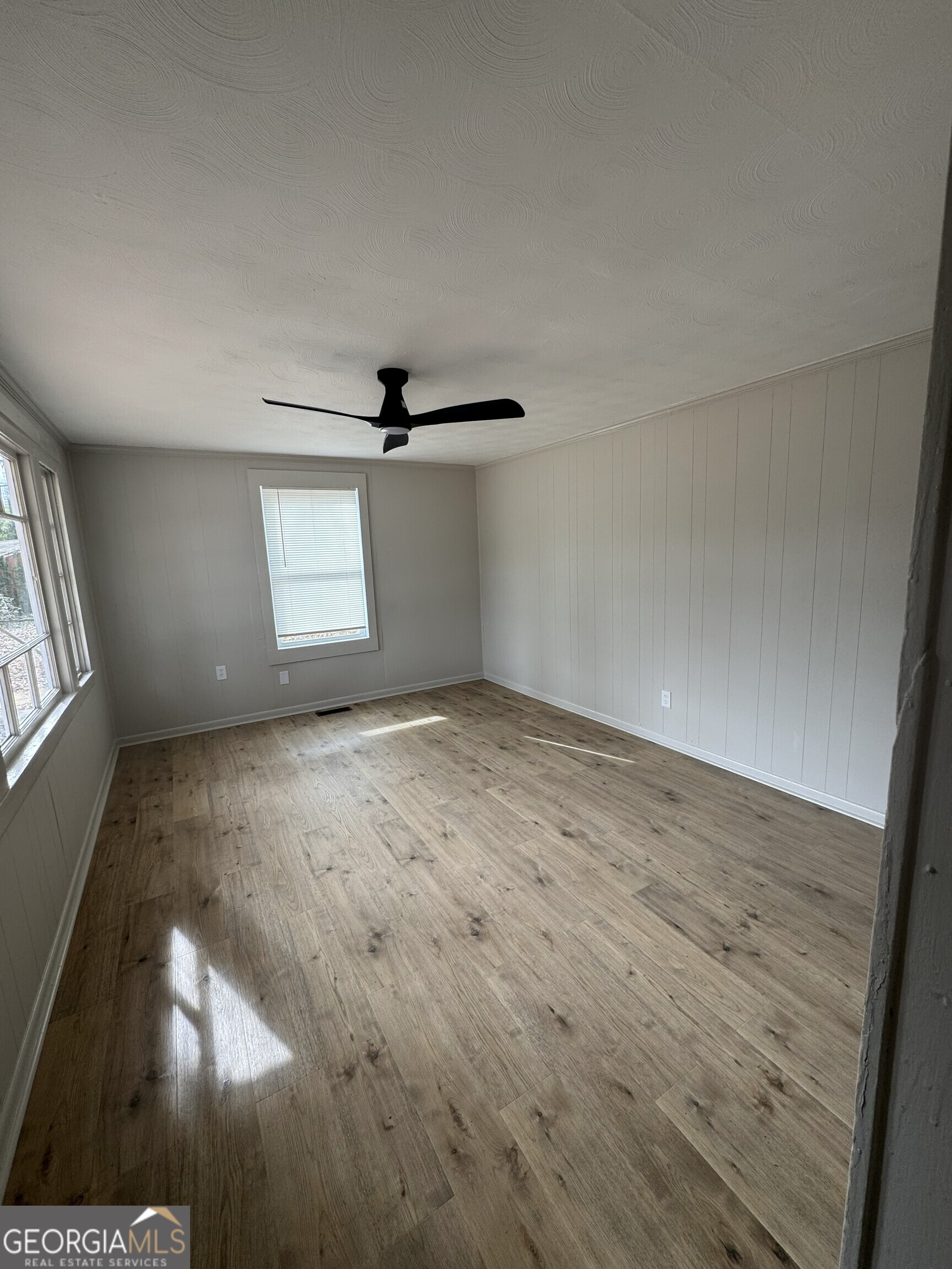 2970 Emerson Circle Macon, GA 31206 - Photo 12 of 12 an empty room with wooden floor fan and windows