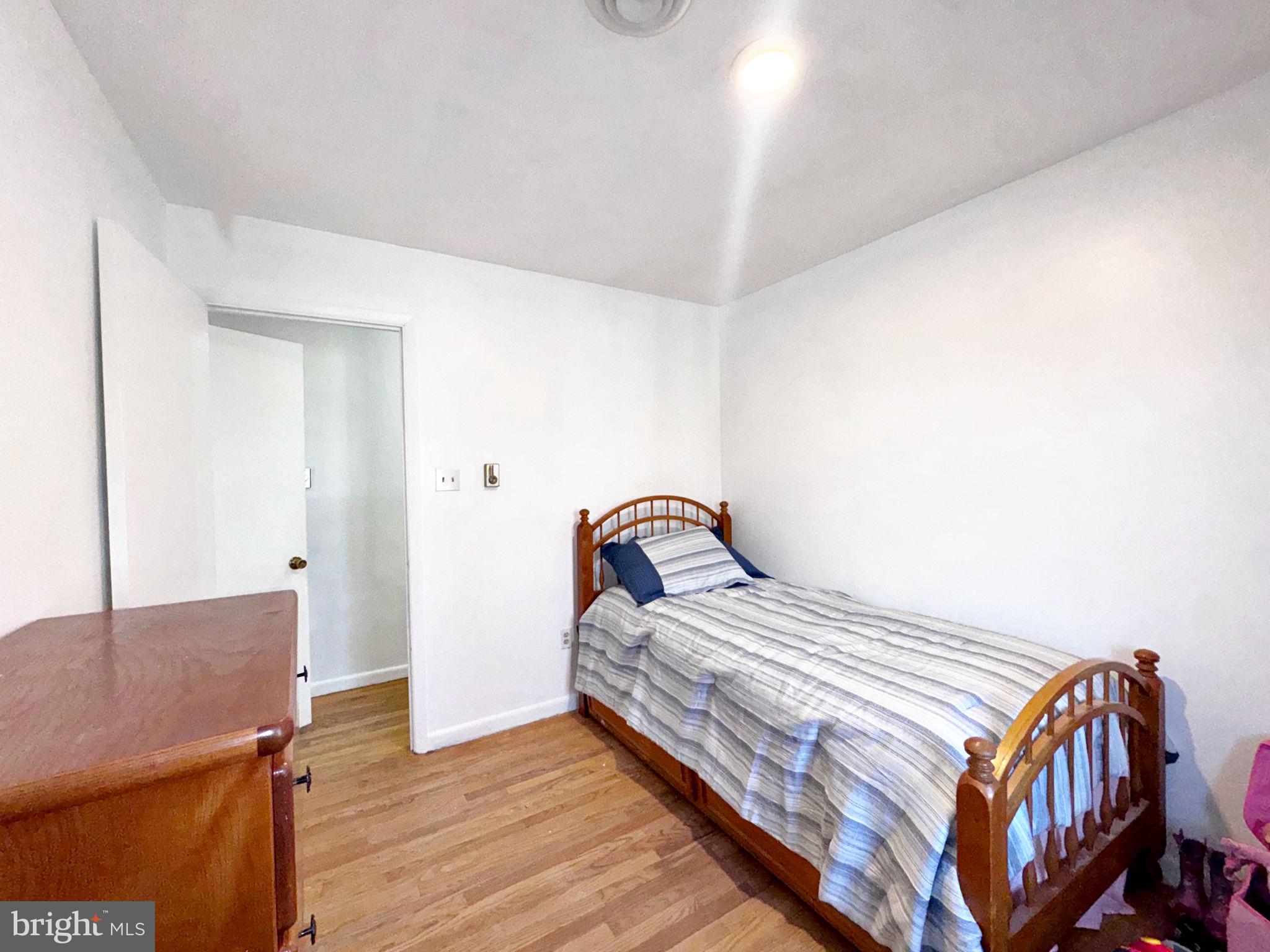 133 Lemon Road Ranson, WV 25438 - Photo 15 of 26 a bedroom with a bed and wooden floor