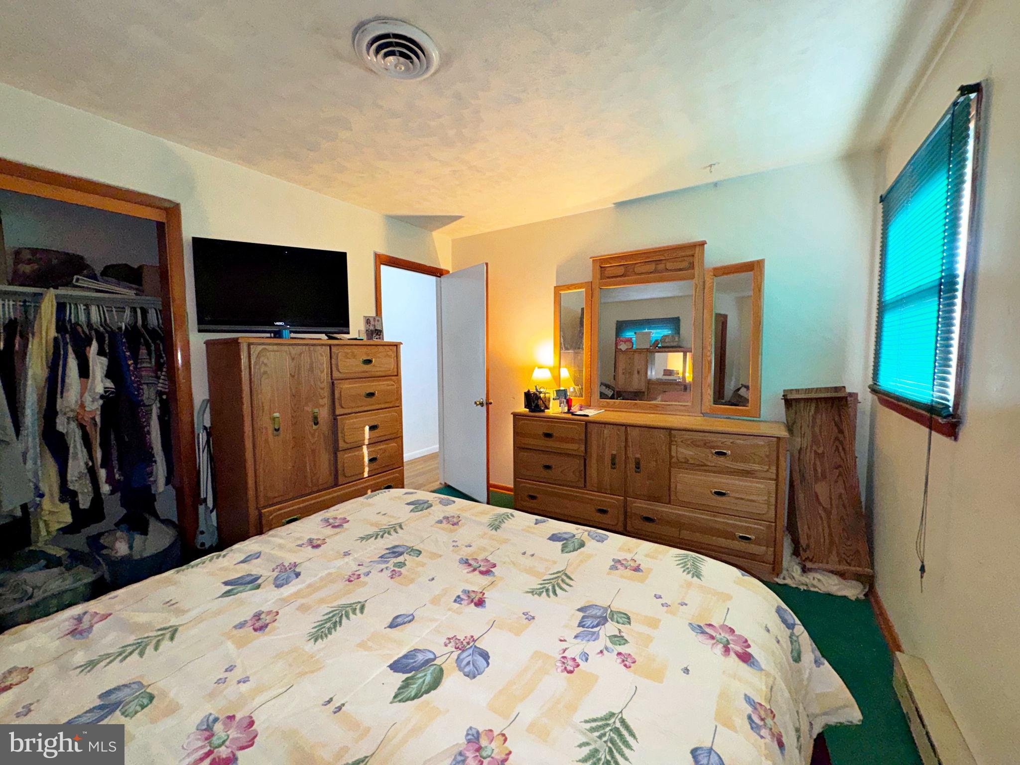 133 Lemon Road Ranson, WV 25438 - Photo 17 of 26 a bed room with a bed a television and dresser