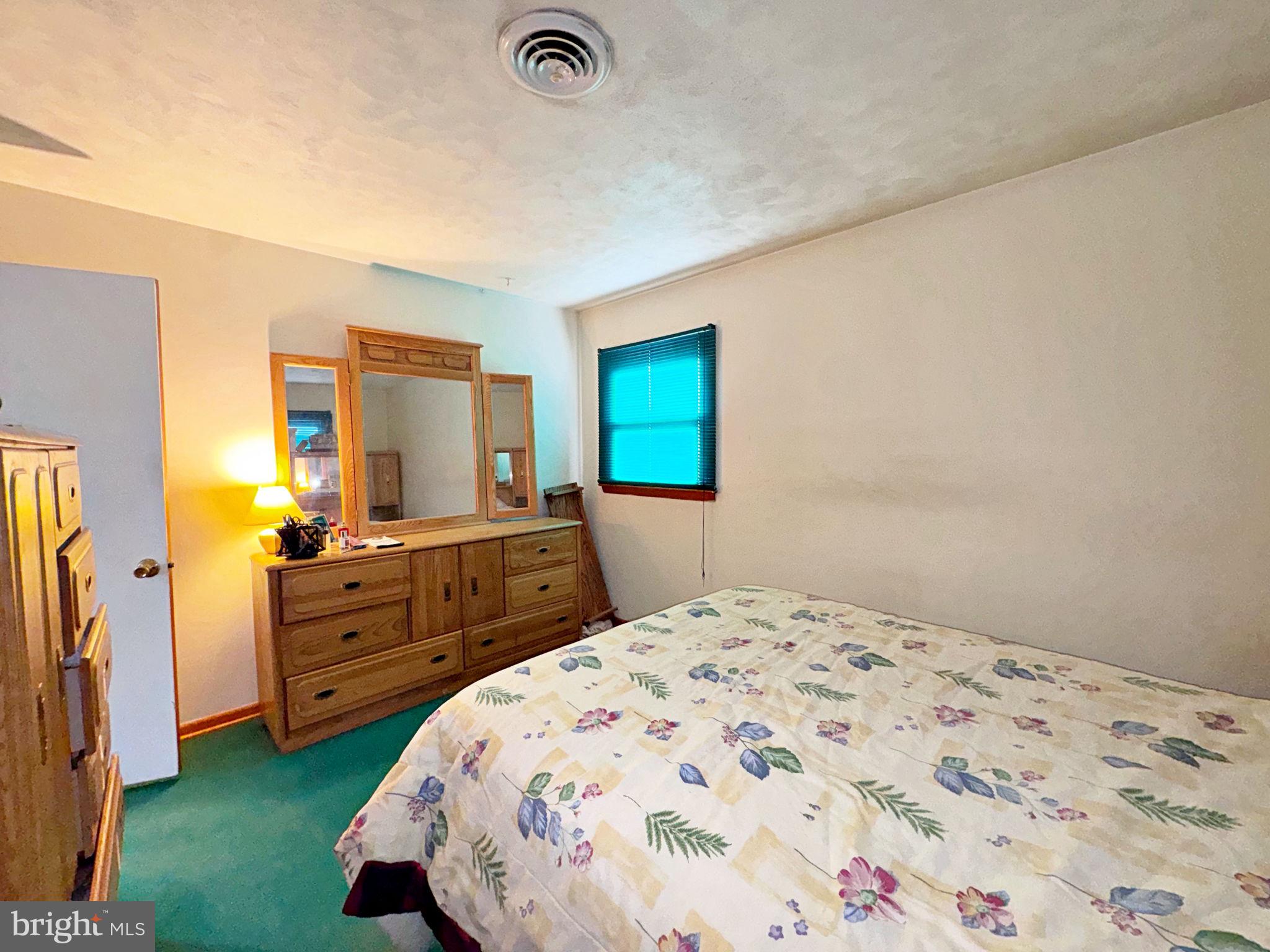 133 Lemon Road Ranson, WV 25438 - Photo 18 of 26 a bedroom with a bed and a dresser