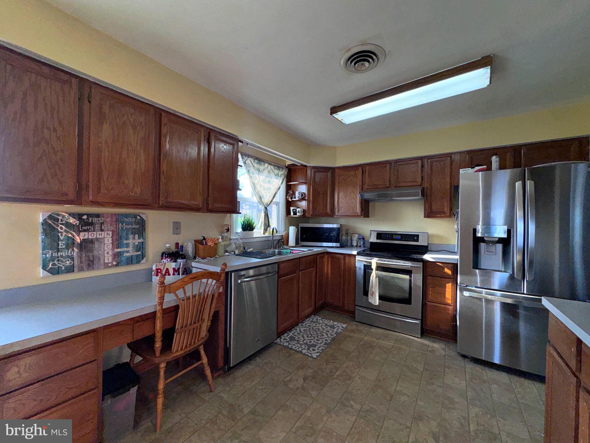 133 Lemon Road Ranson, WV 25438 - Photo 6 of 26 a kitchen with granite countertop stainless steel appliances and wooden cabinets