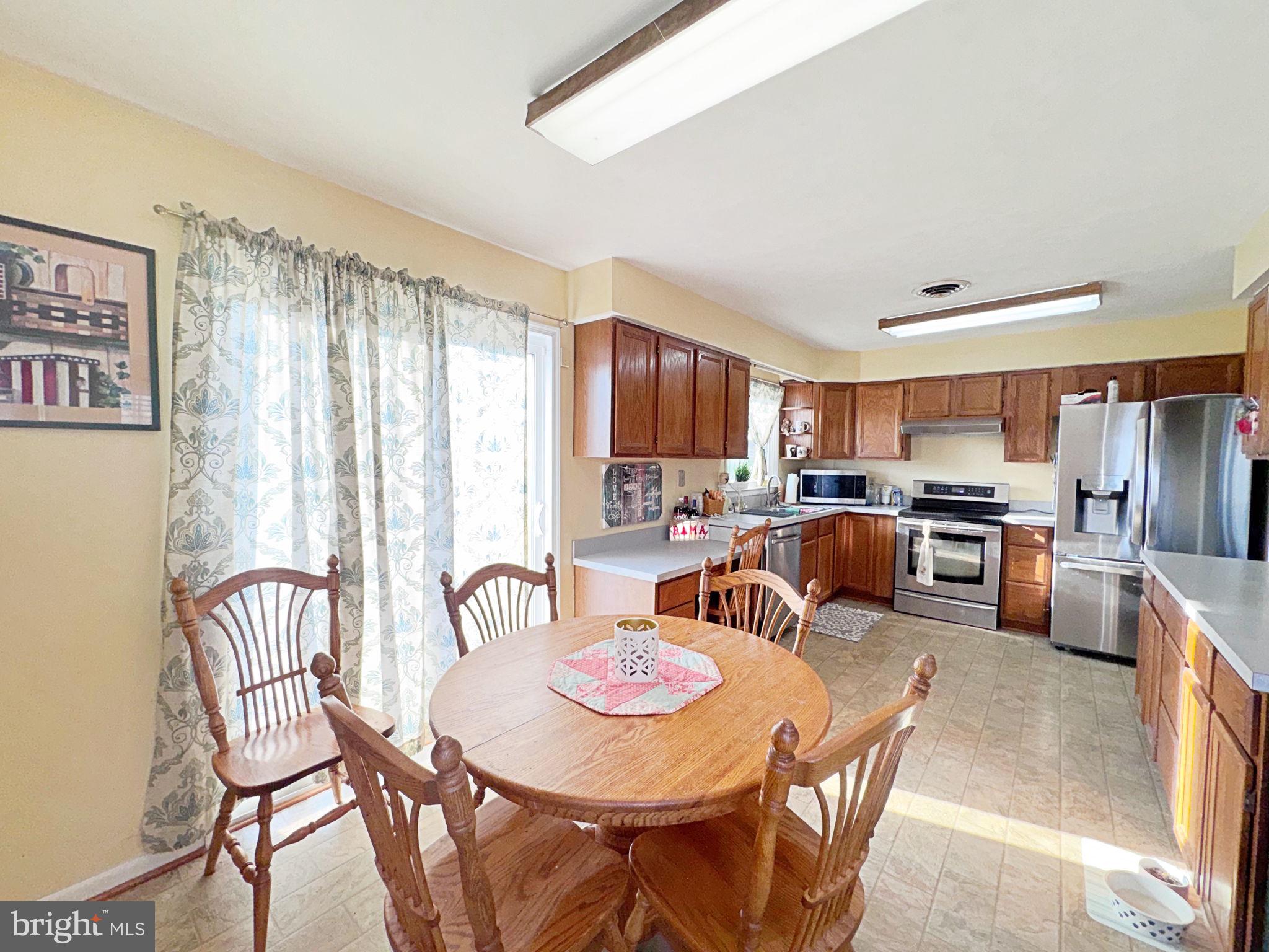 133 Lemon Road Ranson, WV 25438 - Photo 8 of 26 a open kitchen with stainless steel appliances granite countertop a dining table and chairs