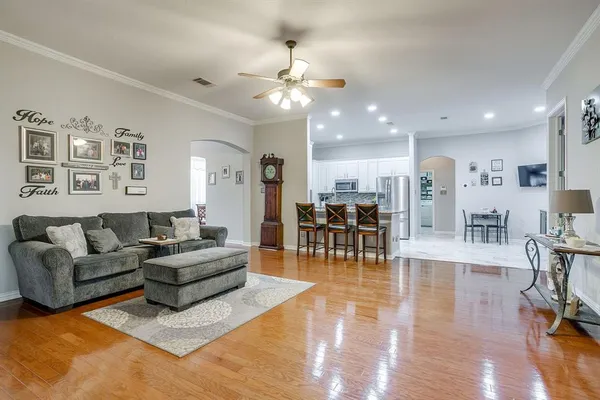 a living room with furniture and wooden floor