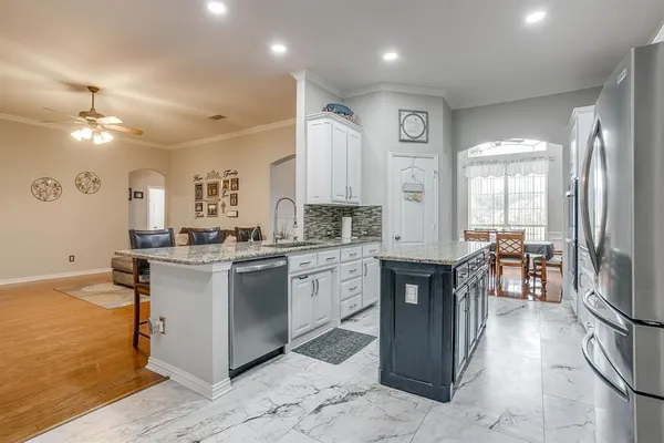a kitchen with stainless steel appliances granite countertop sink stove top oven and cabinets