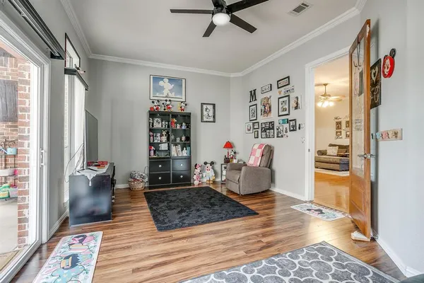 a living room with furniture and a book shelf