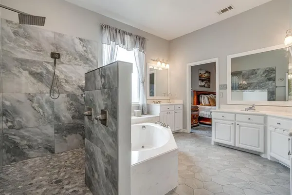 a bathroom with a granite countertop sink a toilet and shower