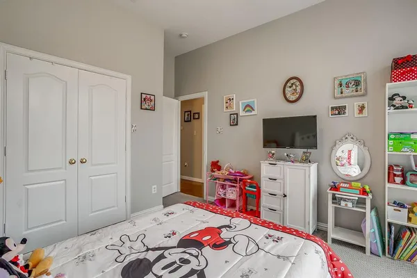 a bedroom that has a bed and a tv in it