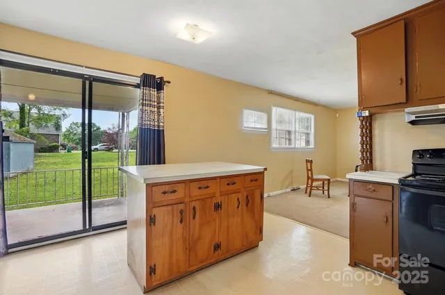 a kitchen with a stove a refrigerator and wooden cabinets
