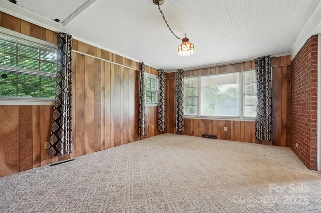 a view of a room with a large bed and large window