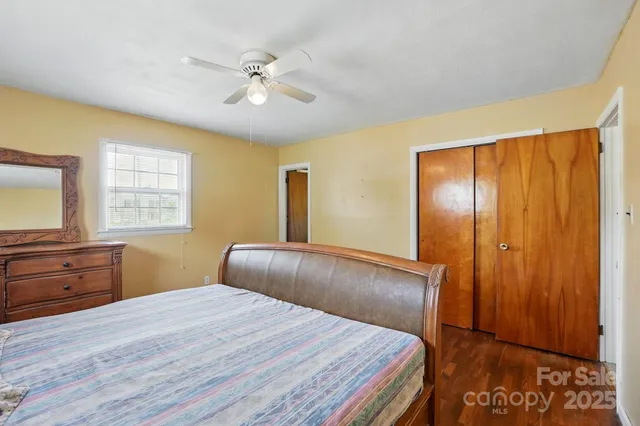 a bedroom with a large bed and a dresser