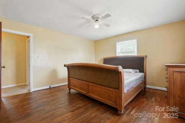 a bedroom with a bed and a ceiling fan