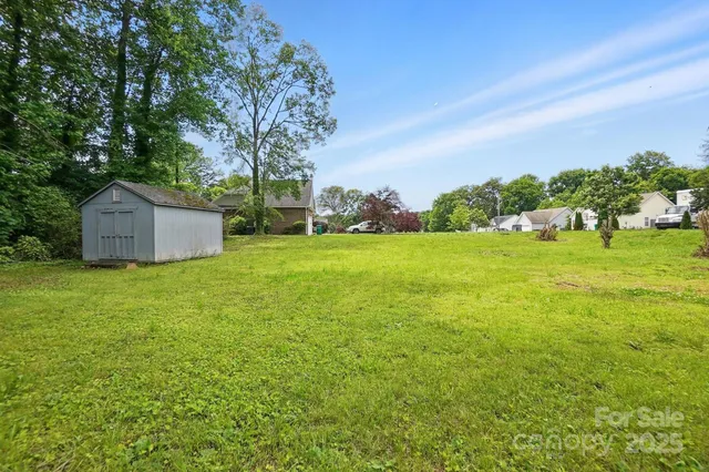a backyard of a house with lots of green space and fountain