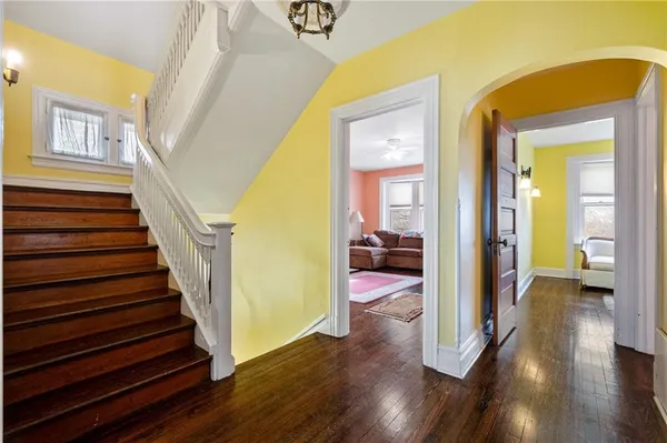 a view of a hallway view with wooden floor and staircase