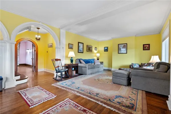 a living room with furniture fireplace and wooden floor