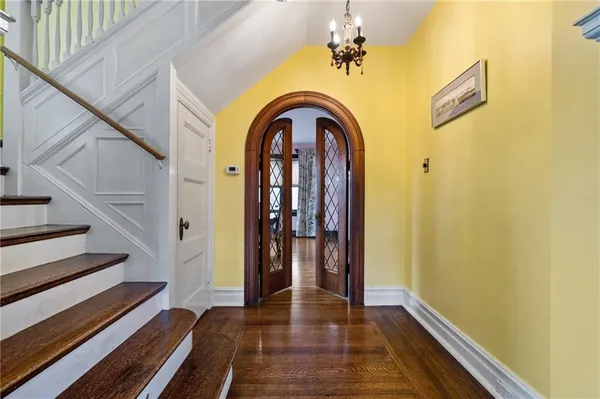 a view of a hallway with wooden floor and staircase