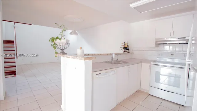 a kitchen with a sink and cabinets