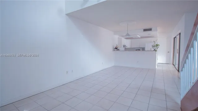 a view of a refrigerator and more cabinets