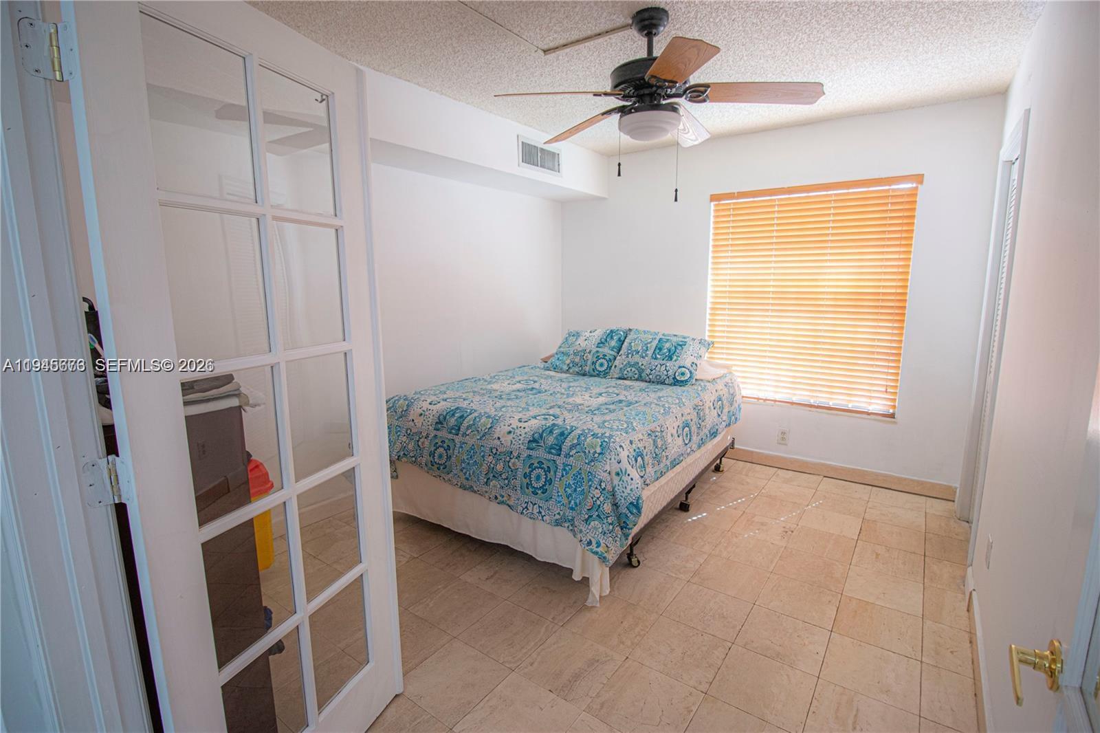 10099 Northwest 4th Lane, Unit 39 Miami, FL 33172 - Photo 7 of 16 a bedroom with a bed and a window