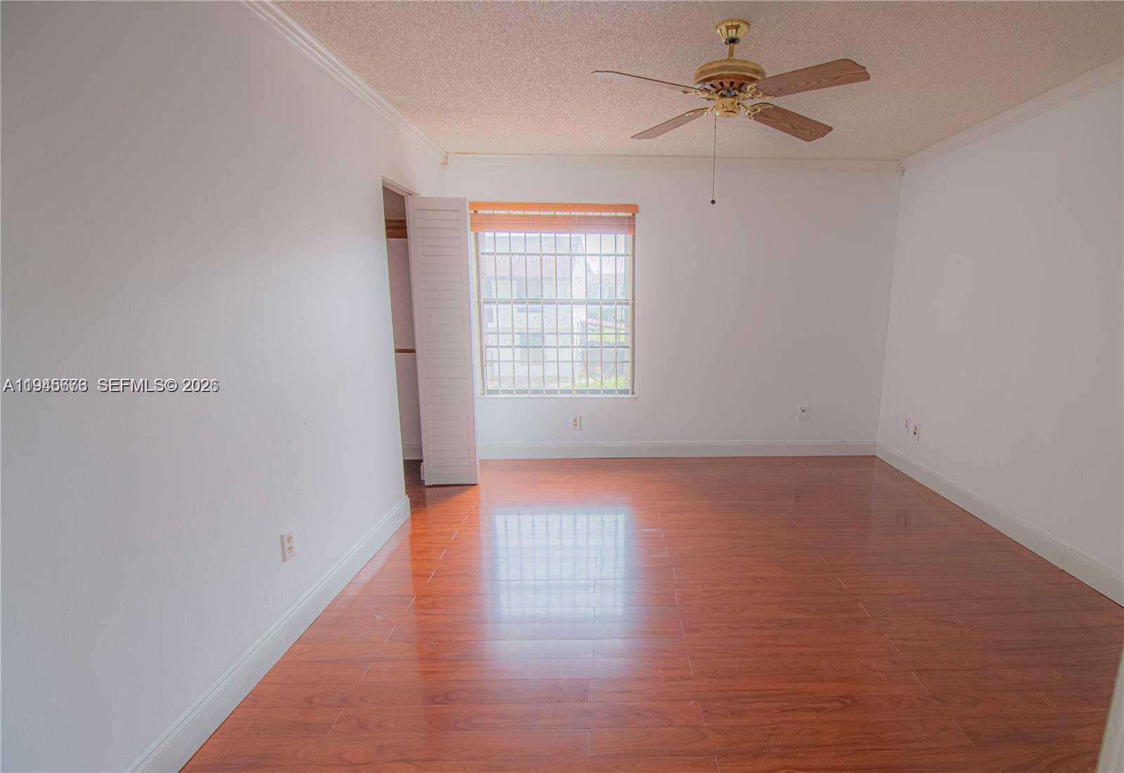 10099 Northwest 4th Lane, Unit 39 Miami, FL 33172 - Photo 9 of 16 wooden floor in an empty room with a window