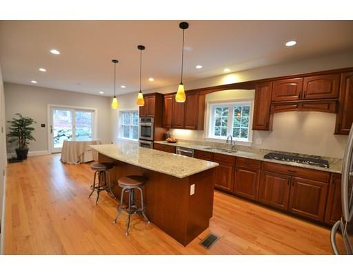 3 Stonefield Circle Winchester, MA 01890 - Photo 5 of 25 a kitchen with stainless steel appliances granite countertop a stove a sink dishwasher and a dining table with wooden floor