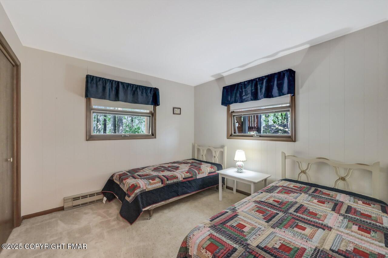 117 Winding Hill Road Pocono Pines, PA 18350 - Photo 14 of 19 a bedroom with a bed and a lamp on table