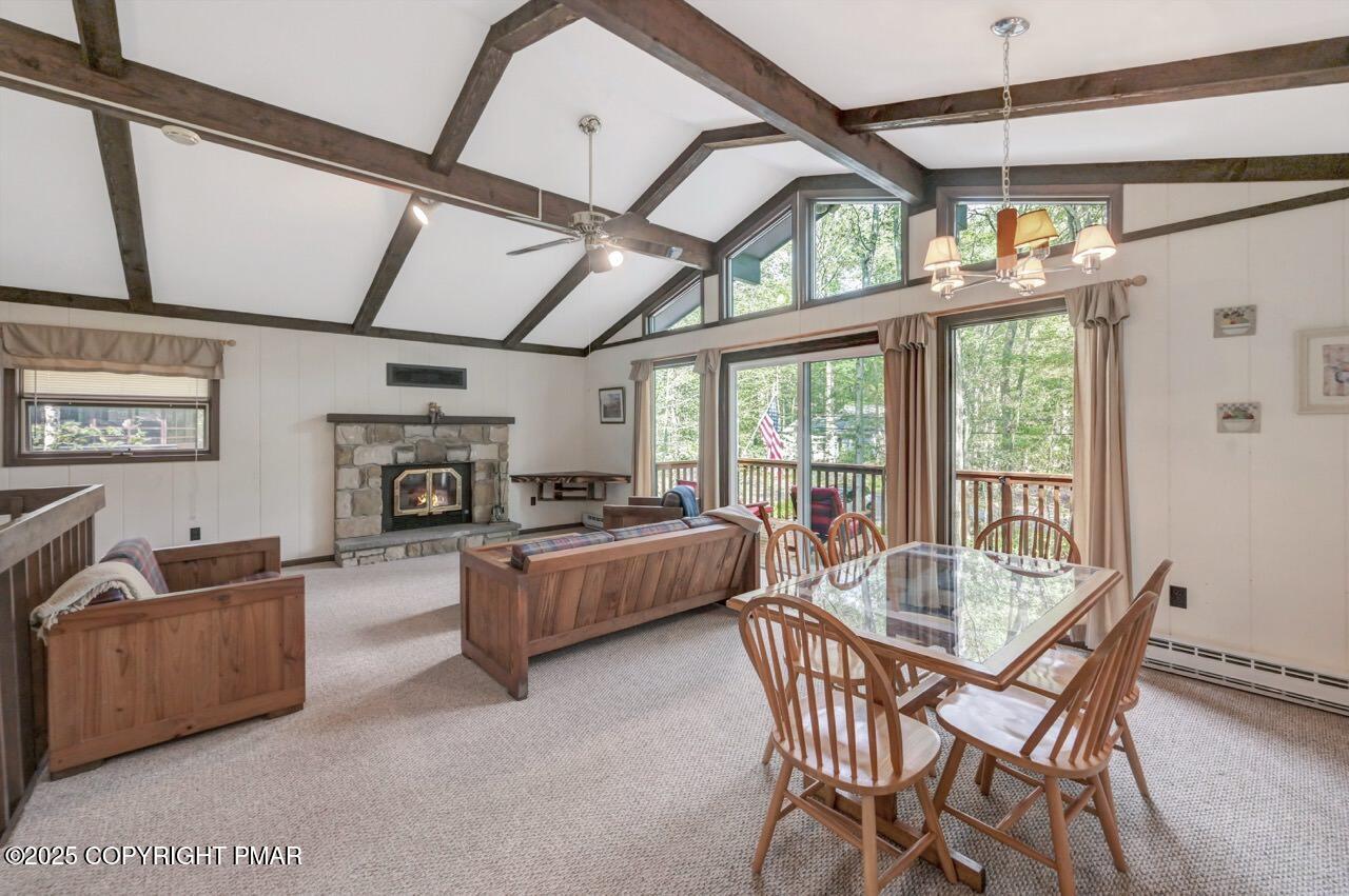 117 Winding Hill Road Pocono Pines, PA 18350 - Photo 2 of 19 a living room with furniture a fireplace and a large window