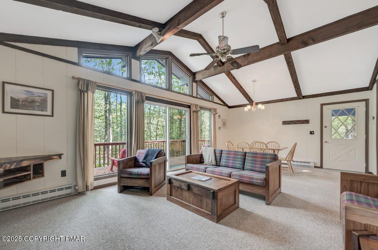 117 Winding Hill Road Pocono Pines, PA 18350 - Photo 4 of 19 a living room with furniture a flat screen tv and a window