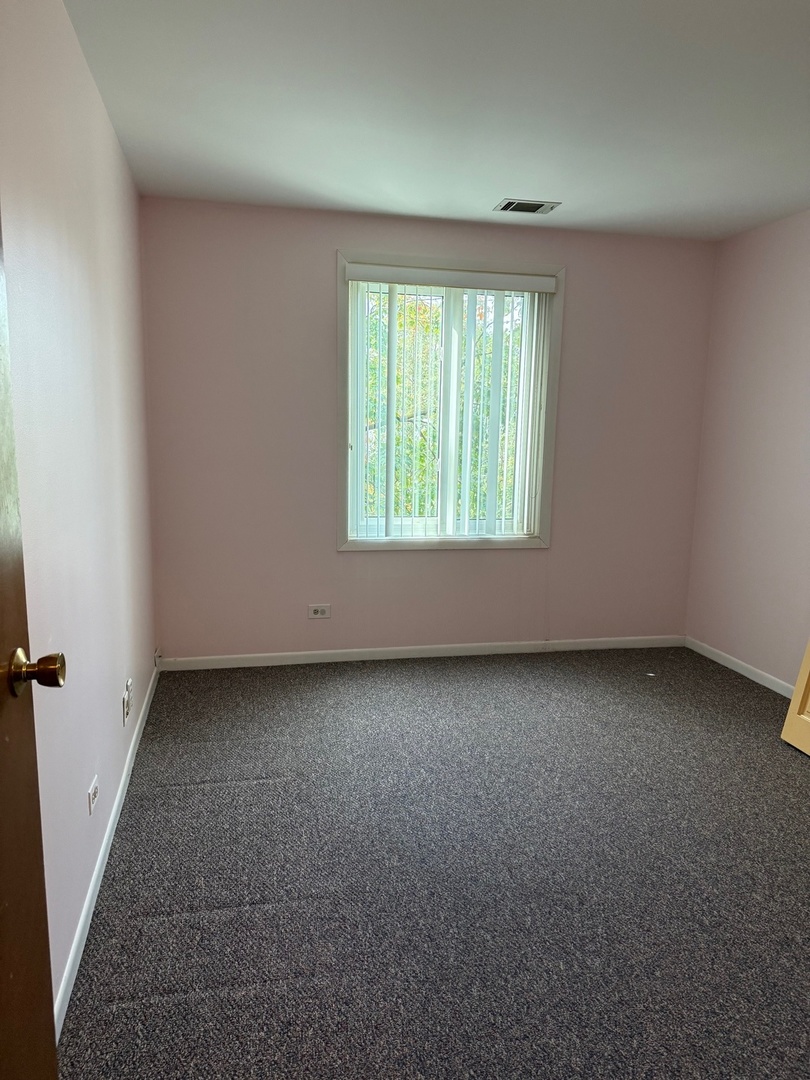 801 79th Street, Unit 310 Darien, IL 60561 - Photo 14 of 18 an empty room with a window