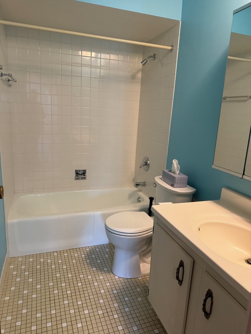 801 79th Street, Unit 310 Darien, IL 60561 - Photo 17 of 18 a bathroom with a sink a toilet and a bathtub