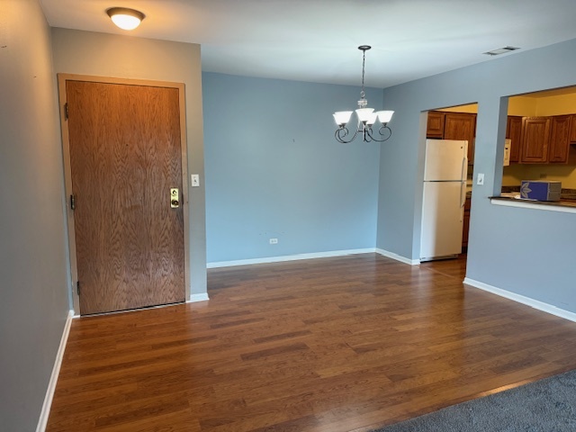 801 79th Street, Unit 310 Darien, IL 60561 - Photo 3 of 18 wooden floor in an empty room with a window