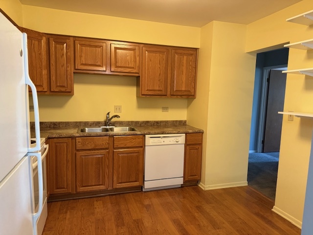 801 79th Street, Unit 310 Darien, IL 60561 - Photo 6 of 18 a kitchen with stainless steel appliances granite countertop a refrigerator sink and cabinets