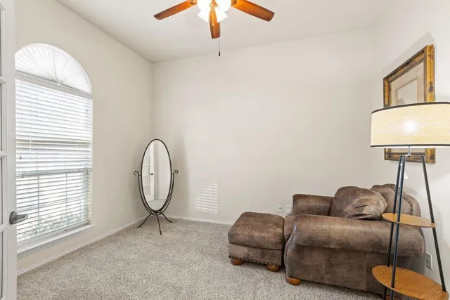 a living room with furniture a lamp and a window