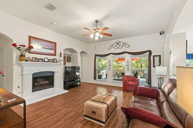a living room with furniture a fireplace and a large window