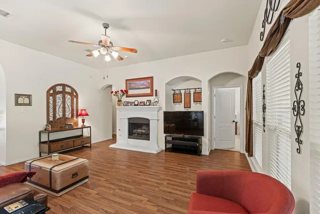 a living room with furniture a fireplace and a flat screen tv