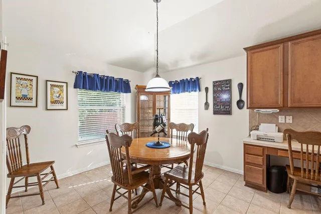 a dining room with furniture and window