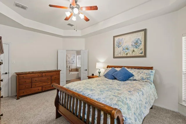 a bedroom with a bed and dresser