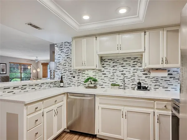 a kitchen with stainless steel appliances granite countertop a sink and cabinets