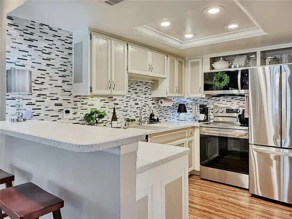 a kitchen with stainless steel appliances a stove sink and microwave