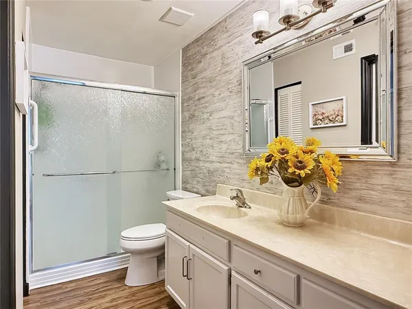 a bathroom with a sink toilet and shower