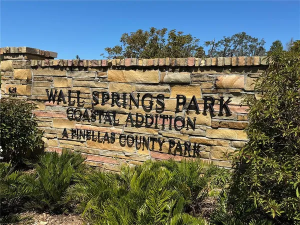 a view of balcony with wooden floor and seating