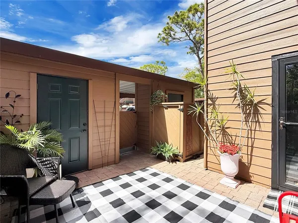 a backyard of a house with potted plants